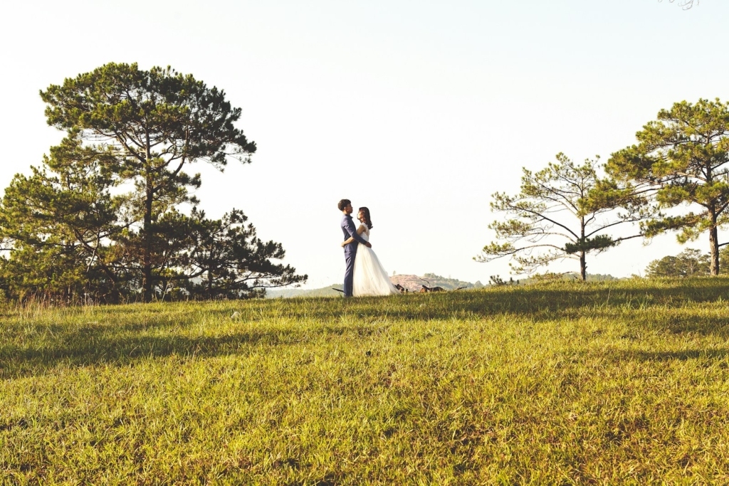 groom and bride near tree