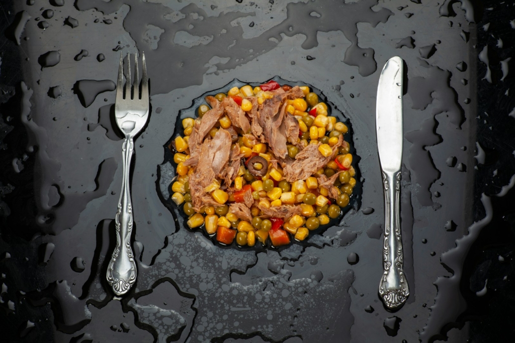 stainless steel fork and bread knife on black ceramic plate